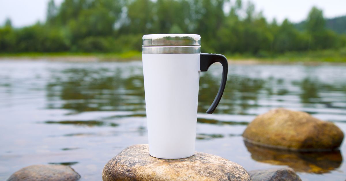 Thermos on a rock surrounded by a river