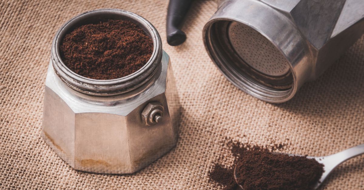 Open moka pot with coffee grounds in it