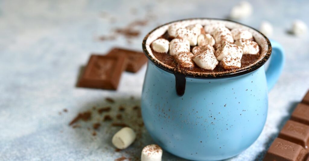 hot chocolate with marshmallows on top in a blue mug