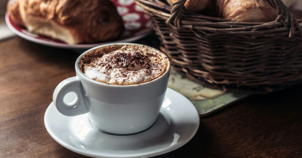 hot chocolate with some pastries in the background