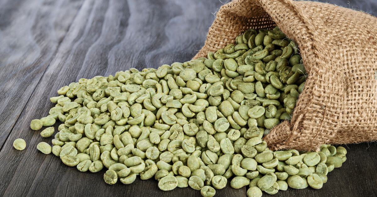 Green coffee beans next to a hessian bag