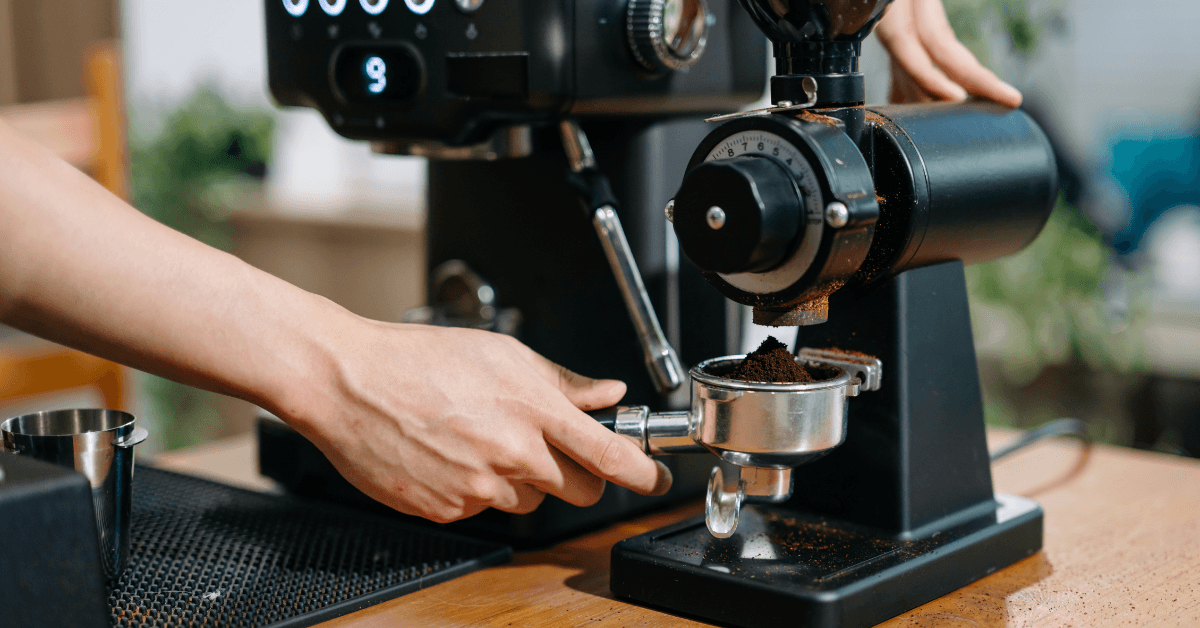 Separate coffee grinder and espresso machine preparing fresh espresso