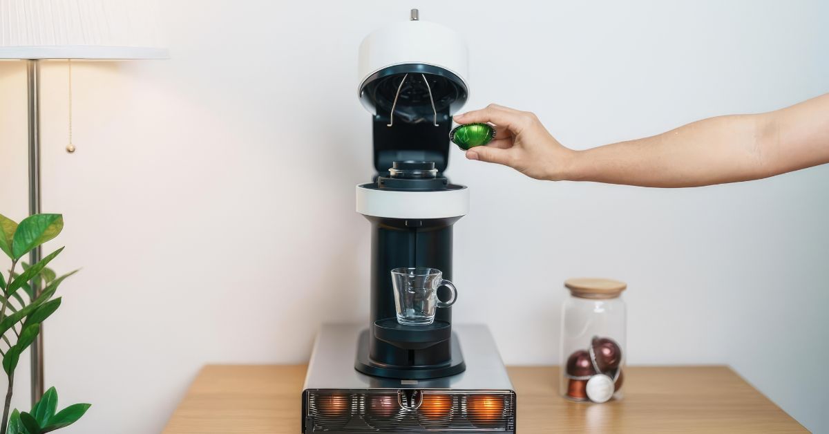 Person using a pod coffee machine