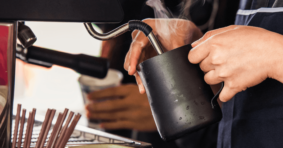 Person steaming milk